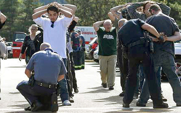 Police search students outside Umpqua Community College in Roseburg Oregon folloiwing the deadly shooting