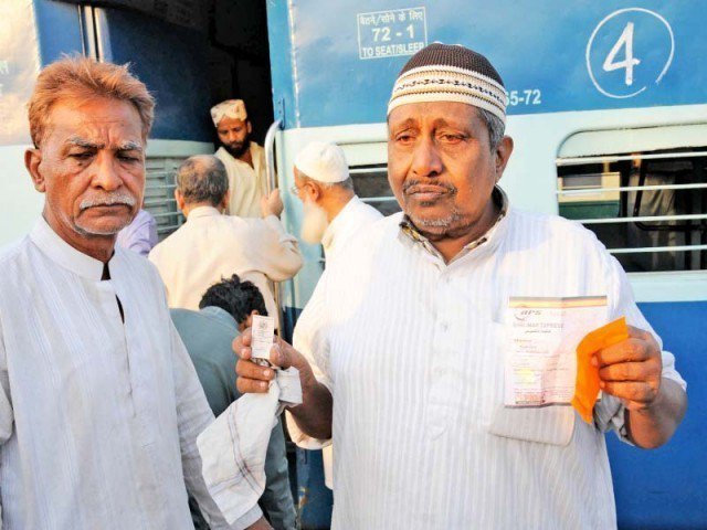 Passengers disembark from the train after it was called back to Lahore