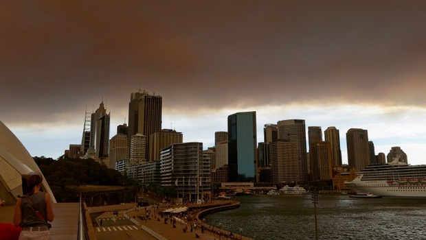 Smoke and ash from wildfires burning across the state of New South Wales blankets the Sydney city skyline. |AFP