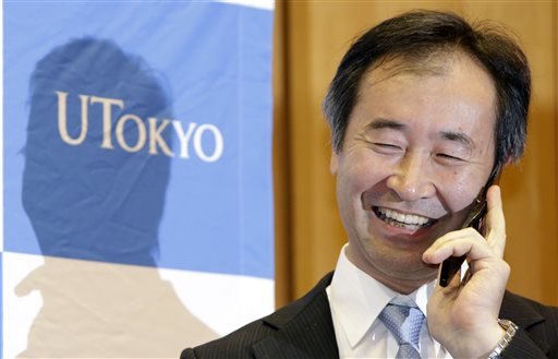 Takaaki Kajita of Japan director of the Institute for Cosmic Ray Research and professor at the University of Tokyo speaks with Japanese Prime Minister Shinzo Abe on the phone after learning he won the Nobel Prize in physics at the university in Tokyo