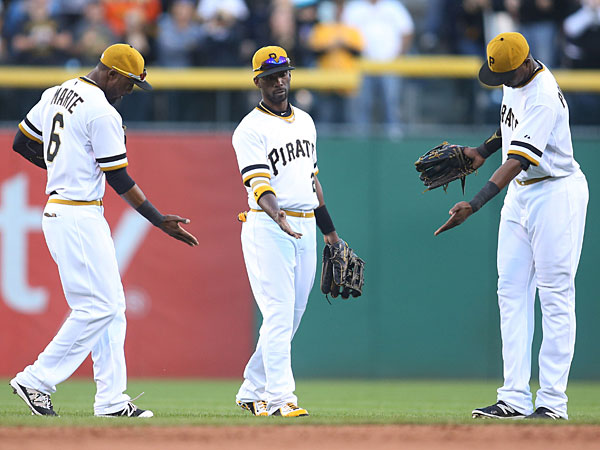 Pittsburgh Pirates outfielders Starling Marte and Andrew Mc Cutchen and Gregory Polanco celebrate in the outfield after defeating the Cincinnati Reds at PNC Park. The Pirates won 4-0