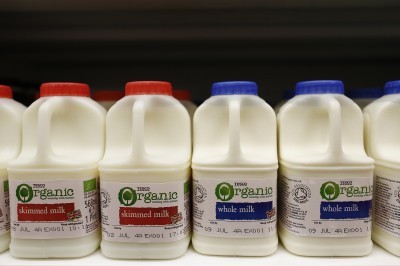 Plastic cartons of organic skimmed milk left and whole milk