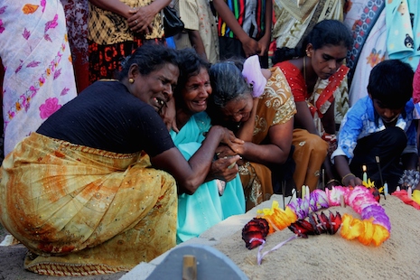 Sri Lankan Tamil women cry at the graves of relatives who died in fighting in Mullivaikkal which witnessed some of the worst atrocities during the last phase of the armed conflict in 2009