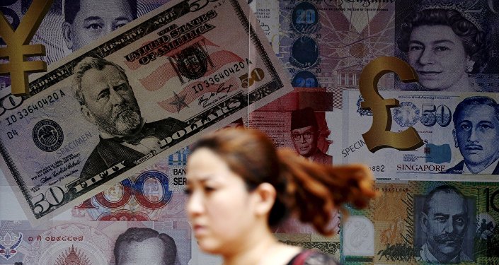 A woman walks past a money exchange shop in Kuala Lumpur Malaysia in this