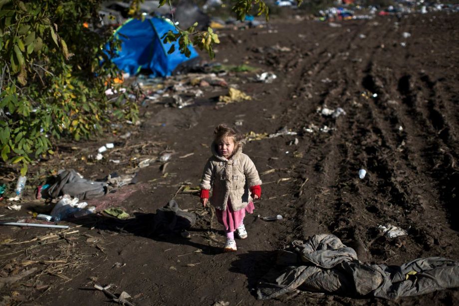 A child walks down a path in a field close to Serbia's border with Croatia in Berkasovo Serbia Sunday Oct. 25 2015. Thousands of migrants and refugees are still crossing from Serbia into Croatia and continuing their journey towards Western Europe. Ph