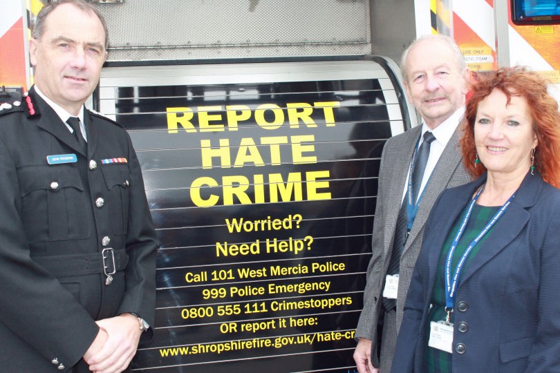 Chief Fire Officer John Redmond Fire Authority Chair Coun Stuart West Hate Crime Reporting Group Chair Coun Jean Jones unveil new hate crime posters