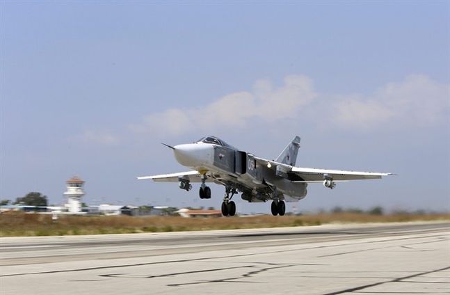 Russian SU-24M jet fighter armed with laser guided bombs takes off from a runaway at Hmeimim airbase in Syria. Russia and the United States signed an agreement Oct. 20 designed to minimize the risk of collisions