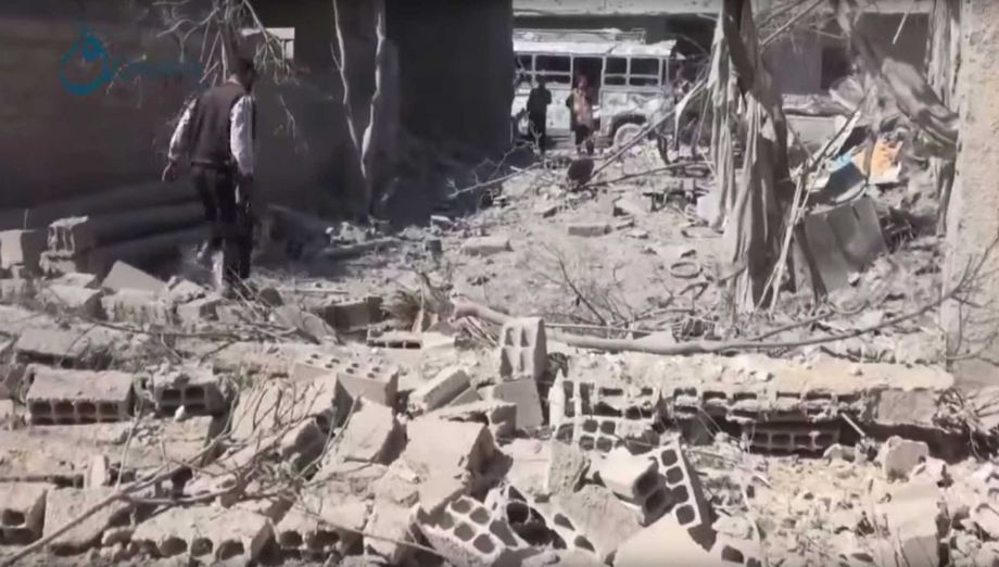 In this Thursday Oct. 1 2015 image taken from video provided by the Syrian activist-based media group Qasioun News which has-been verified and is consistent with other AP reporting a man walks over the rubble of a destroyed building in the aftermath