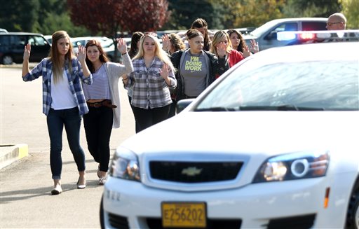 Students staff and faculty are evacuated from Umpqua Community College in Roseburg Ore. Thursday Oct. 1 2015 after a deadly shooting. MANDATORY CREDIT