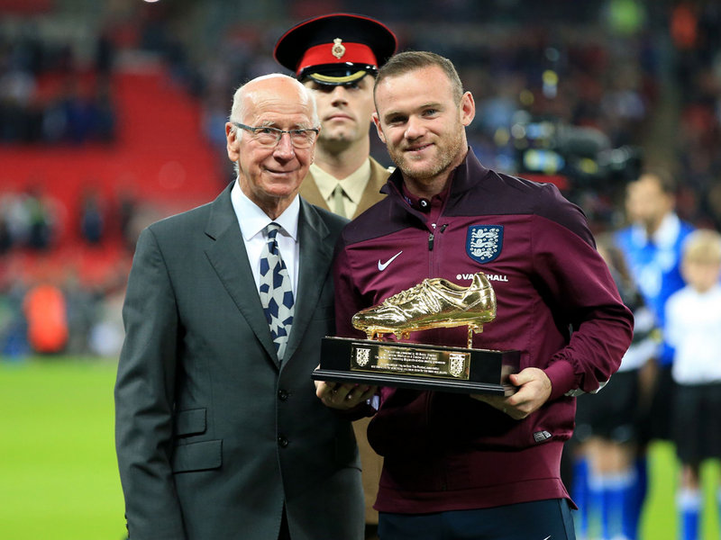 Sir Bobby Charlton presents England's Wayne Rooney with a golden boot on Friday night