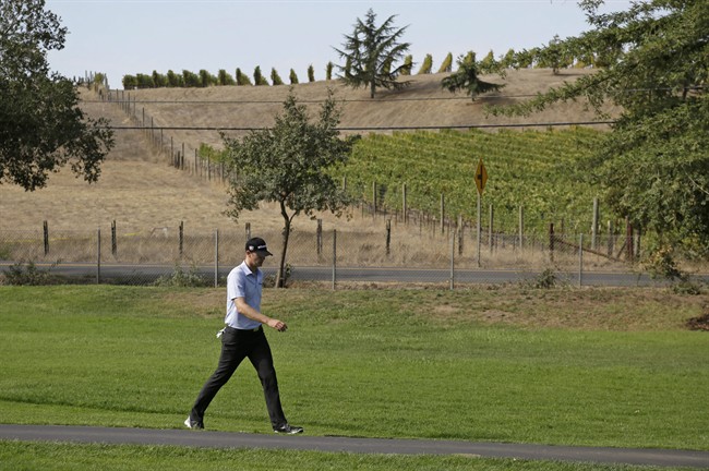 Brendan Steele walks up the third fairway of the Silverado Resort North Course with vineyards in the background during the first round of the