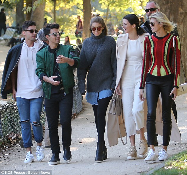 Stylish friends Gigi Hadid Joe Jonas Kendall Jenner and Devon Winsdor strolled through Monceau park in Paris on Friday