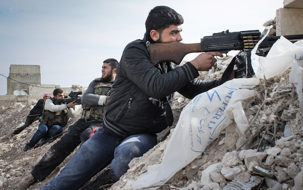 Syrian rebels fight against Assad militias on the outskirts of the northwestern city of Maraat al-Numan Idlib