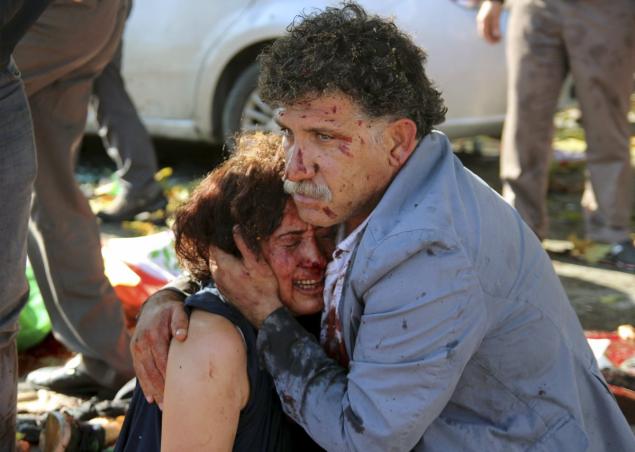 An injured man hugs an injured woman after an explosion during a peace march in Ankara Turkey