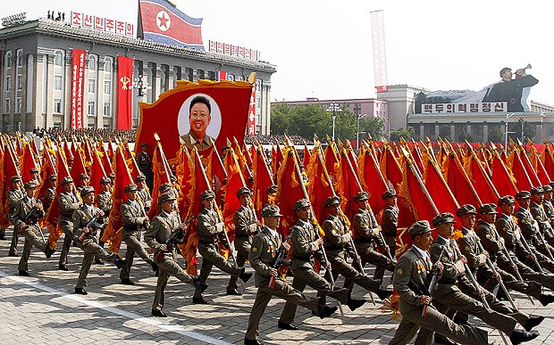 North Korean troops march past a portrait of the late leader Kim Jong Il during a military parade at Kim Il Sung Square to mark the 65th anniversary of the country's founding in Pyongyang North Korea Monday Sept. 9 2013