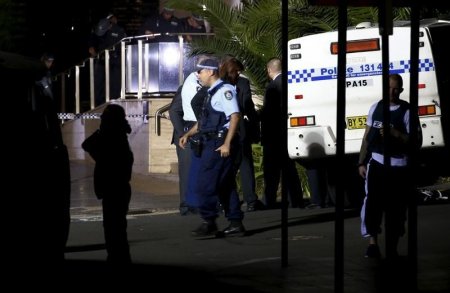 Police inspect and guard the area outside the New South Wales state police headquarters located in the south western Sydney suburb of Parramatta Australia