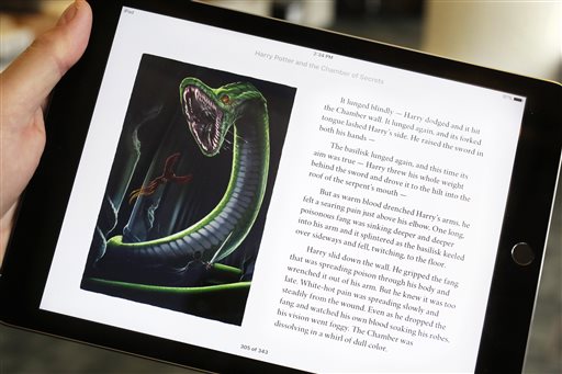 Text and an illustration from'Harry Potter and the Chamber of Secrets are displayed on an iPad Wednesday Sept. 30 2015 in New York. The J.K. Rowling books are being released with animated or interactive illustrations but only through Apples iBook