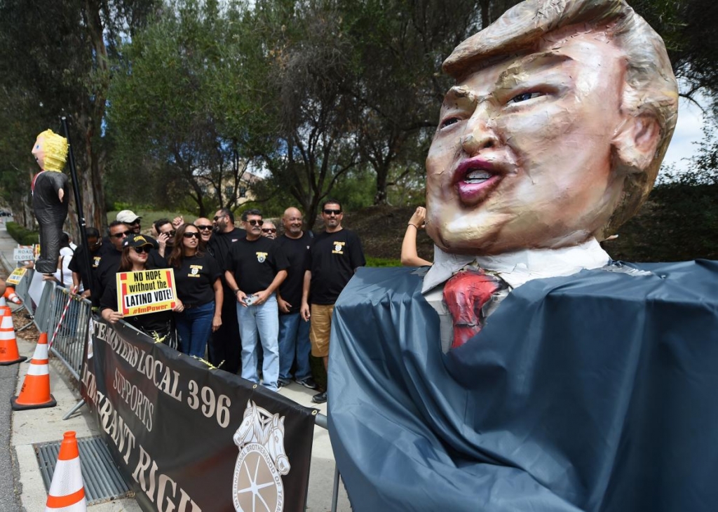 Latinos Teamsters pose beside an effigy of Donald Trump during protests outside the GOP debate in Simi Valley California on Sept. 16 2015