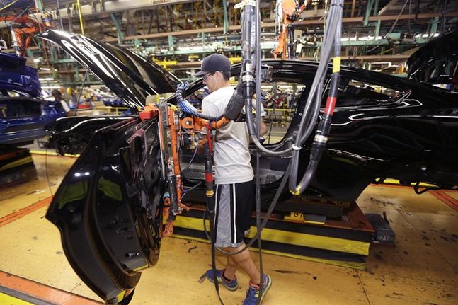 United Auto Workers assemblyman Justin Johnson works on the Ford Mustang at the Flat Rock Assembly Plant in Flat Rock Mich. Economists forecast that industrial production fell 0.3 percent in September 2015 accord