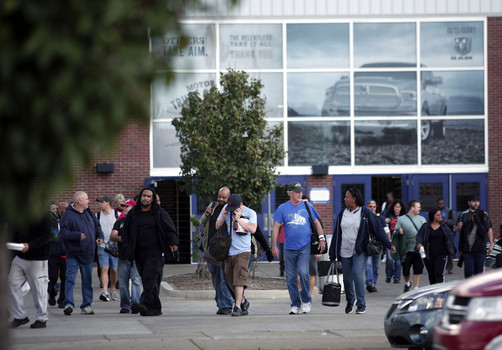 Workers leave a Fiat Chrysler facility recently. They were working under extended contract terms while negotiater worked on an update to 2011 labor pacts. A shutdown was averted early today as a tentative contract was reached