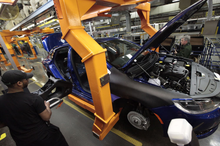 An assembly line worker builds a 2015 Chrysler 200 in Sterling Heights Mich. Fiat Chrysler’s U.S. sales jumped 14 percent in September helped in part by another strong month from the carmaker’s Jeep brand. [Associated Press &#65279