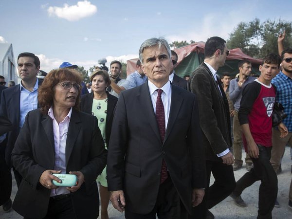 Austrian Chancellor Werner Faymann center visits the Moria camp in Lesbos island, Greece on Tuesday Oct. 6 2015. The Austrian Chancellor and the Greek premier visited Lesbos island Tuesday to view first-hand the impact of the refugee crisis and tour