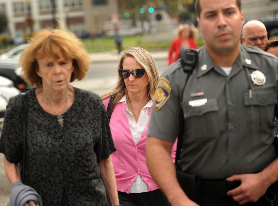 Jennifer Connell center is escorted to her car by marshals after her lawsuit against her Westport nephew was found in his favor in Superior Court in Bridgeport Conn. She sued her nephew who was eight-years-old