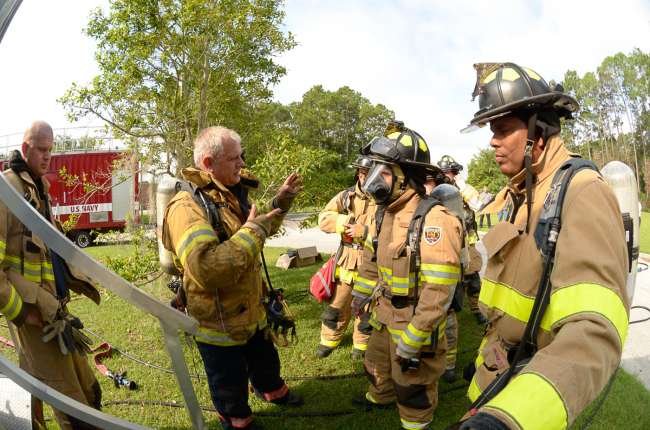 Naval Submarine Base Kings Bay Firefighters discuss tactics during an exercise drill