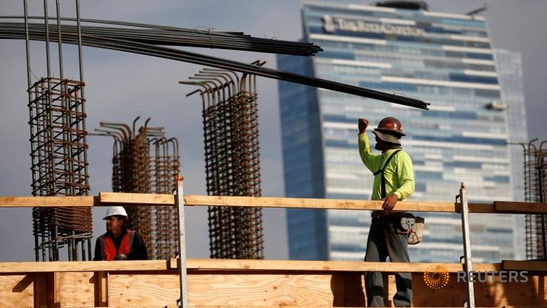 Workers at a construction site for a luxury apartment complex in downtown Los Angeles California USA