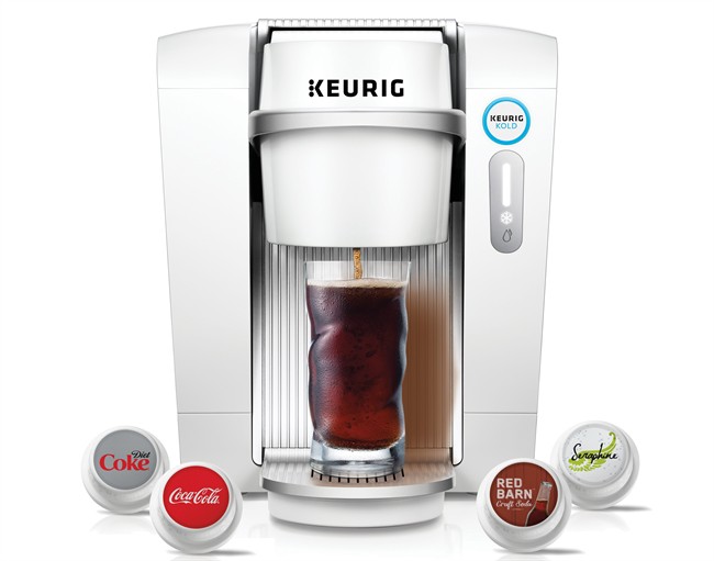 This product image provided by Keurig Green Mountain shows the Keurig Kold machine and single serving pods. Keurig said it will start selling the machine Tuesday Sept. 29 2015 that makes single servings of cold beverages including Coke Sprite Dr. Pep