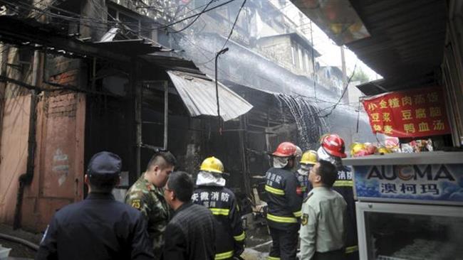 Rescuers try to extinguish a fire after an explosion at a restaurant in eastern China