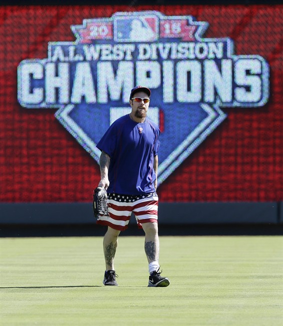 Texas Rangers left fielder Josh Hamilton walks in the outfield during a baseball team workout in Arlington Texas Tuesday Oct. 6