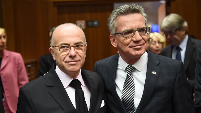 French Interior Minister Bernard and German Interior Minister Thomas de Maiziere arrive to attend an extraordinary Justice and Home Affairs Council following the attacks in Paris at the European Council in Brussels