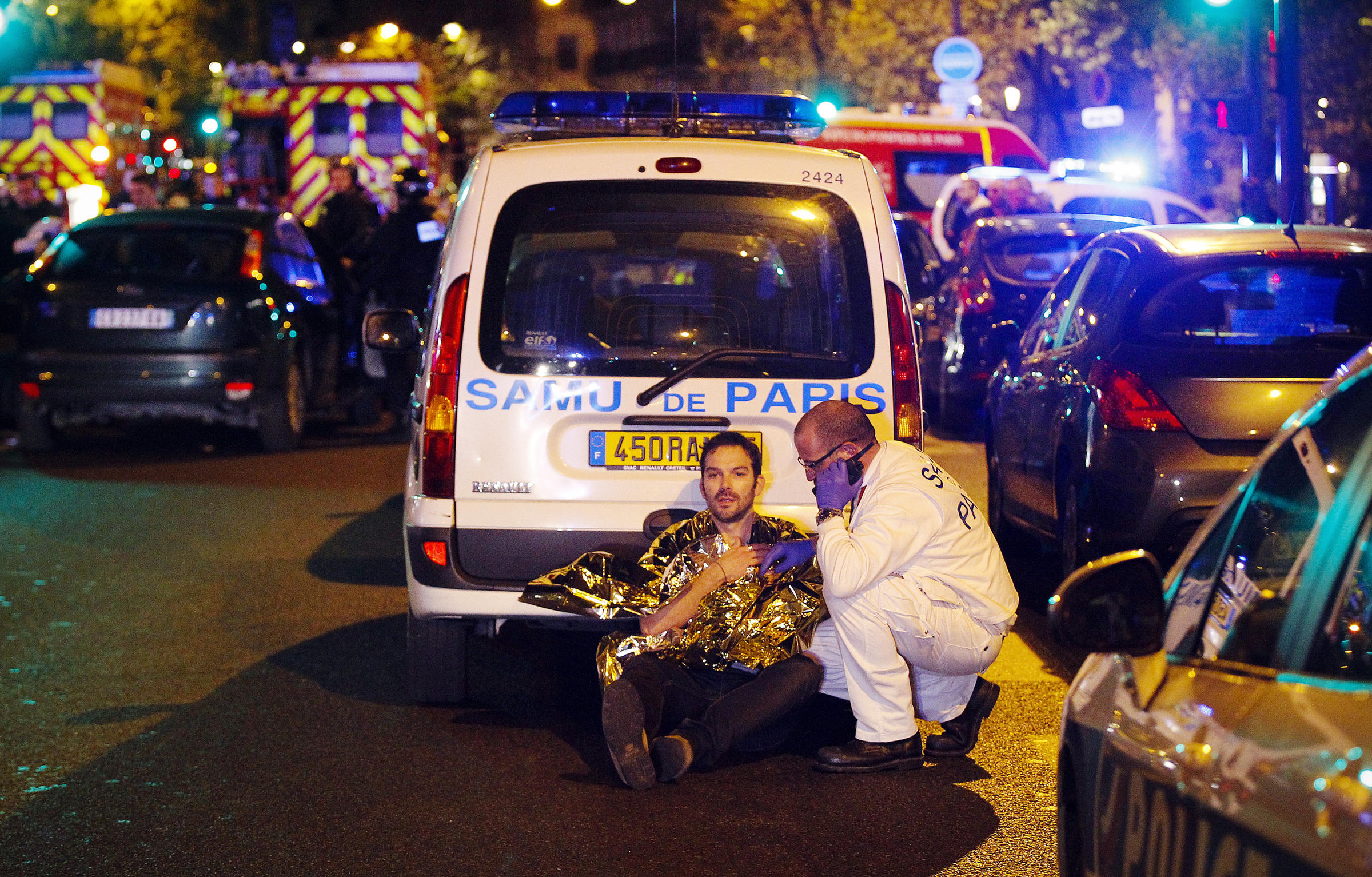 A medic tends to a man injured in the terror attacks in Paris on Friday evening. The Islamic State has claimed responsibility for the coordinated assault that has claimed more than 120 lives