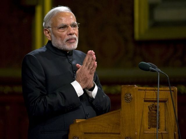 Narendra Modi gestures to members of Britain's Parliament and invited guests in the Royal at the Houses of Parliament in central Lond