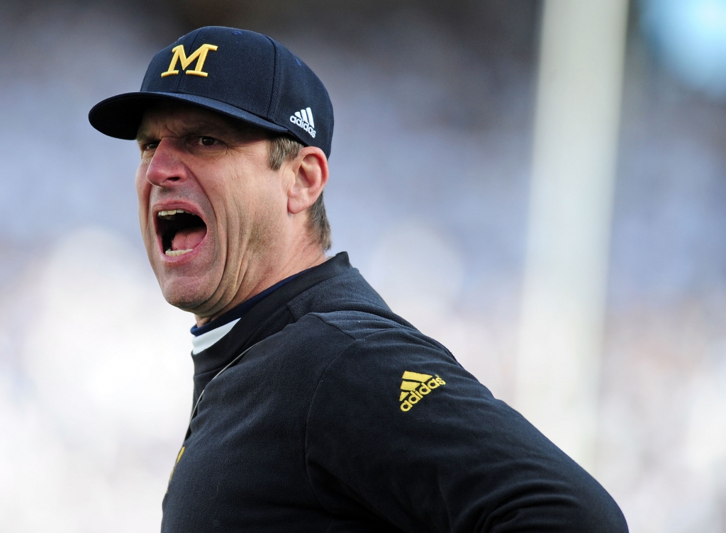 Jim Harbaugh smashed a buckeye with a hammer at Bo Schembechler's grave