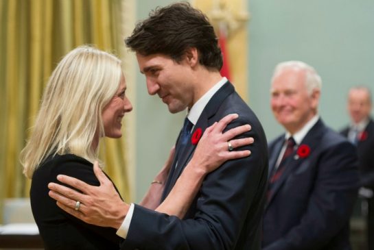 Prime Minister Justin Trudeau hugs Environment and Climate Change Minister Catherine Mc Kenna at Rideau Hall in Ottawa on Wednesday