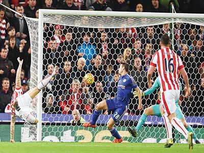 Stoke City’s Austrian striker Marko Arnautovic shoots to score the opening goal of the English Premier League football match between Stoke City and Chelsea at the Britannia Stadium in Stoke-on-Trent central England