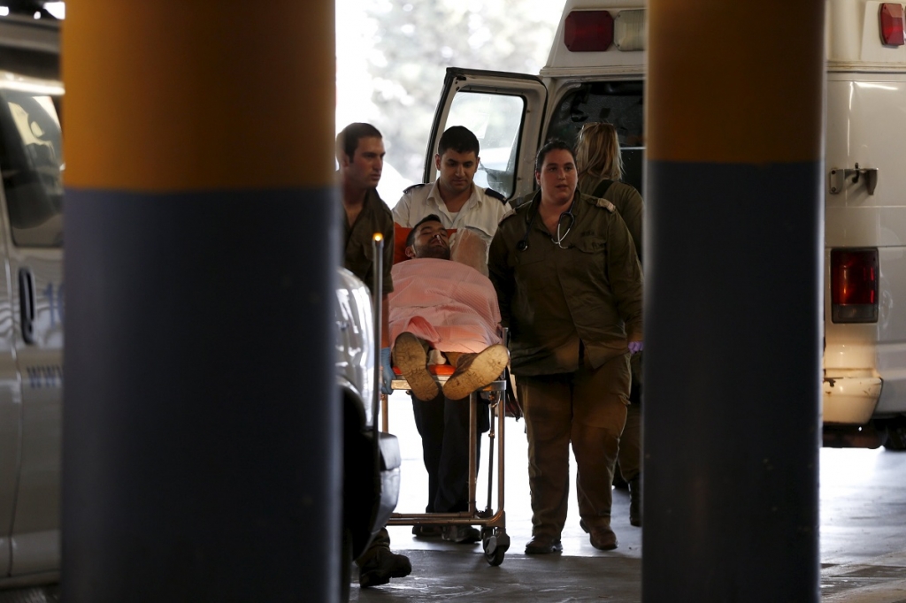 An Israeli medic wheels a soldier one of six wounded in what the Israeli military said was Friday's second Palestinian car ramming attack in the West Bank to a hospital in Jerusalem