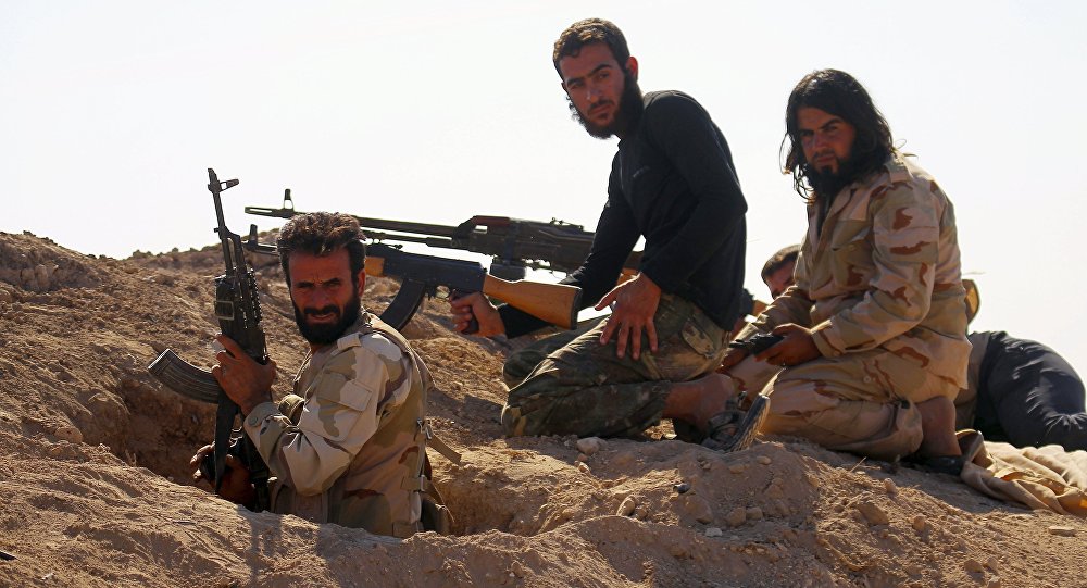 Rebel fighters carry their weapons as they take positions in the town of Kafr Nabudah in Hama province Syria on which forces loyal to Syria's President Bashar al Assad are carrying out offensives to take control of the town