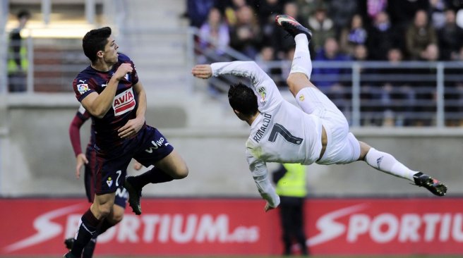 Real Madrid's Portuguese forward Cristiano Ronaldo vies with Eibar's midfielder Ander Capa during the Spanish league football match SD Eibar vs Real Madrid CF at the Ipurua stadium in Eibar