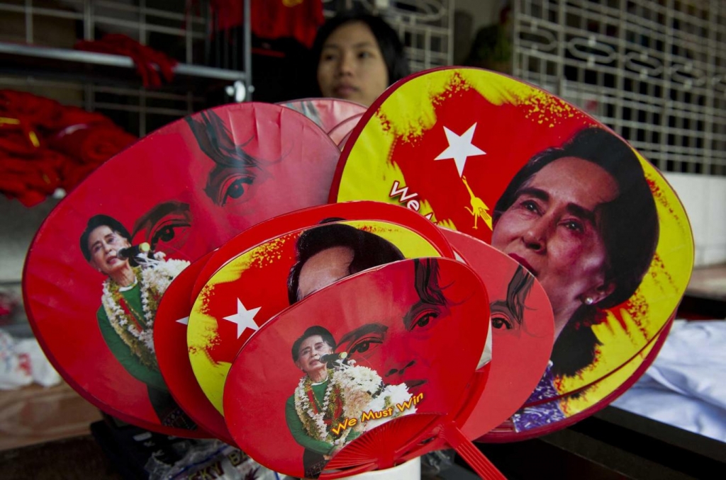 Woman selling fans featuring Aung San Suu Kyi