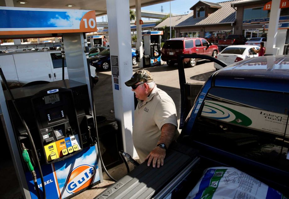 Curtis Floyd watches the gas pump while filling up his Dodge Ram pickup at Fuel City in Dallas. On Friday the national average for a gallon of regular gas was $2.04 — a nickel above the $1.99 that gasoline pricing monitor Gas Buddy had predicted at the