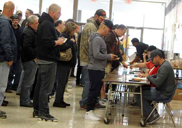 ANNA NORRIS  CHRONICLE Members of local UAW 2000 line up to vote on their new three-year Ford Motor Company contract Sunday morning at Lorain High School