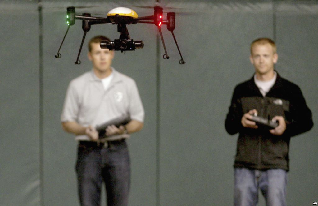 FILE- Students at John D. Odegard School of Aerospace Sciences at the University of North Dakota in Grand Forks North Dakota remotely pilot a drone during a demonstration in