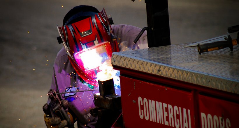 Worker uses a technique called'arc welding to build a moveable gate