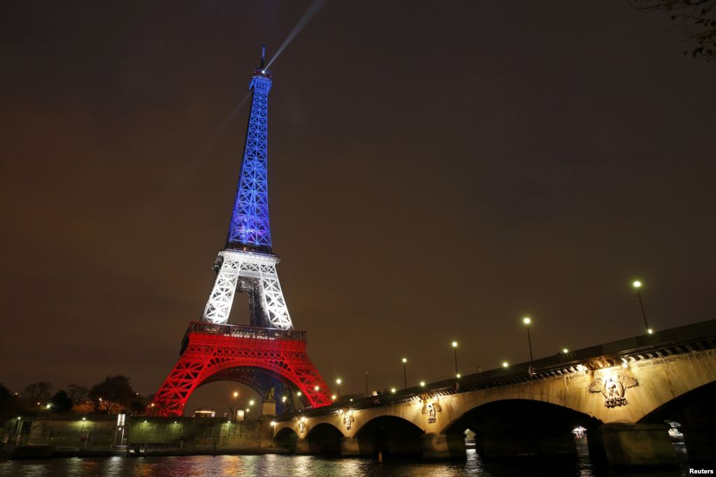 The Eiffel Tower is lit with the blue white and red colors of the French flag in Paris on November 16