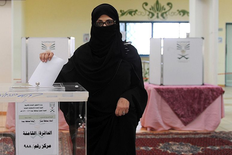 A Saudi woman casts her vote on Dec. 12