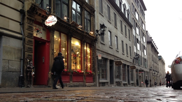 A pedestrian walks thought slowness Old Montreal