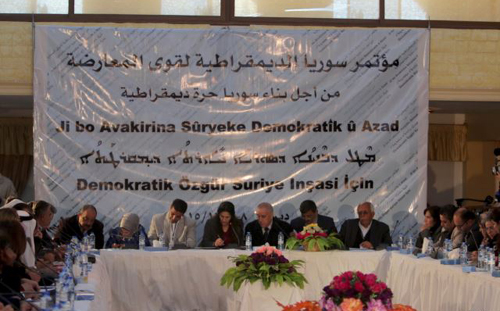 Participants attend a conference held by the Democratic Forces of Syria in Derek Syria on Dec. 8 2015. The text on the banner reads in Arabic